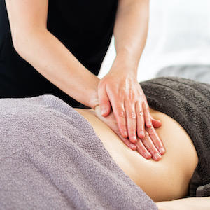 Lower back being massaged